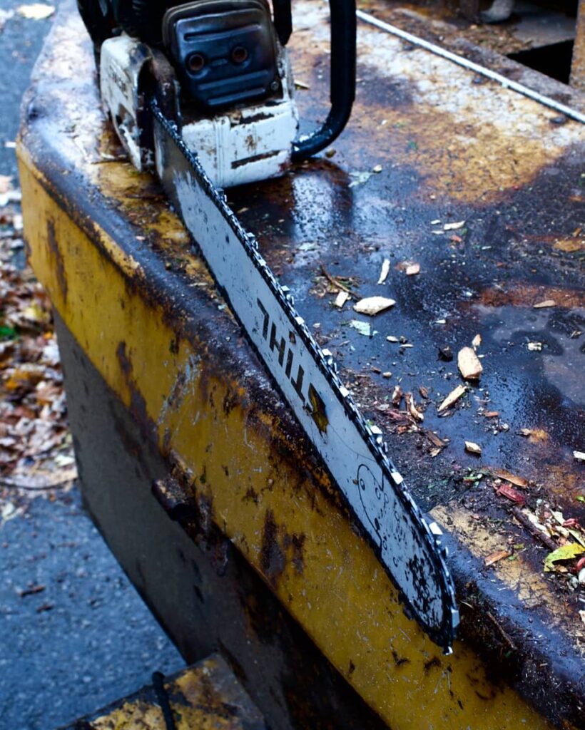 Close up of a STIHL chainsaw resting on the back of a truck