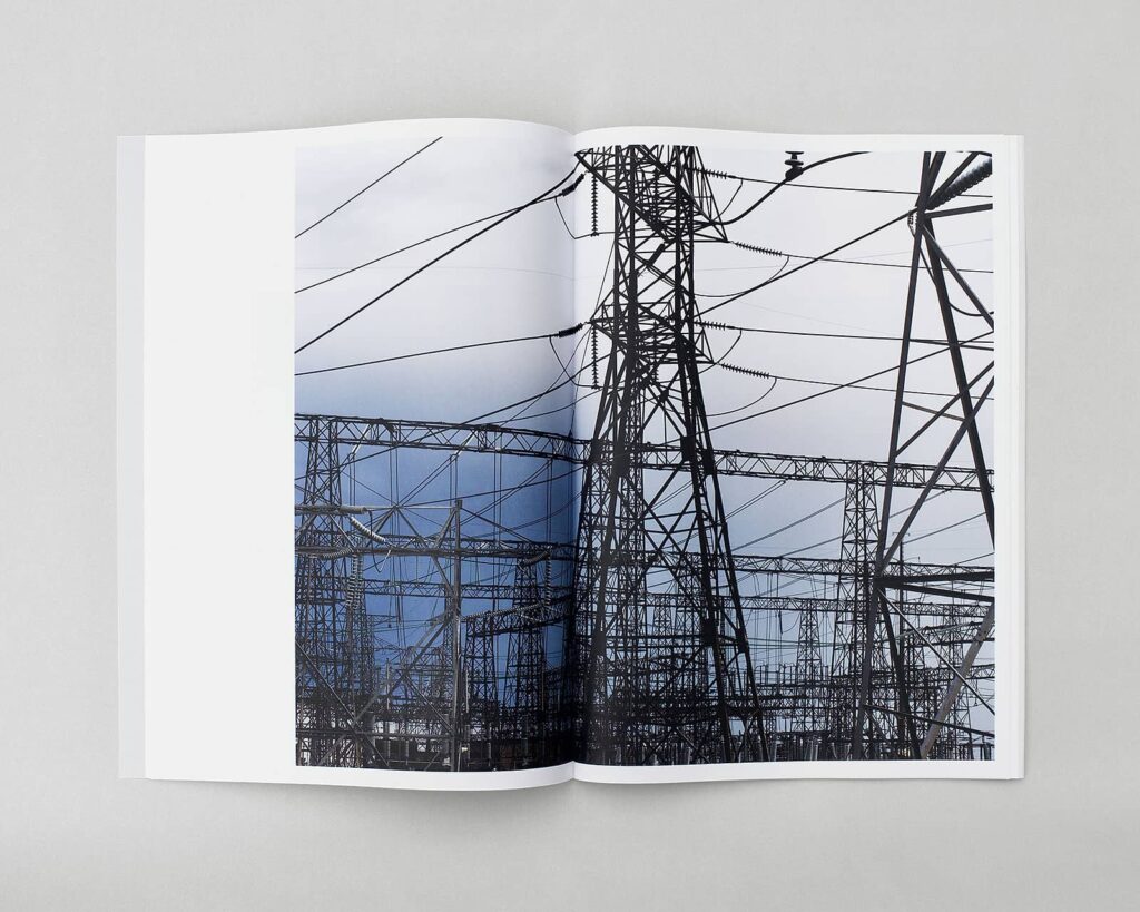 Photobook spread of utility towers after a storm.