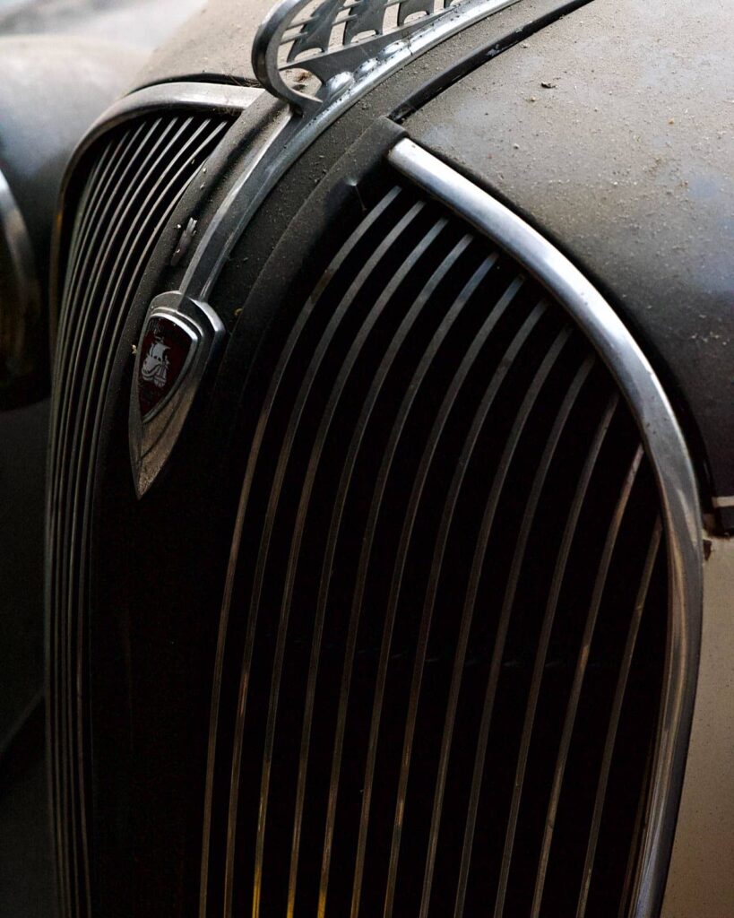 Dusty front grill of a 1932 Plymouth car.
